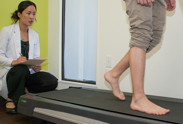 Dr. Alice Wang performing a gait analysis on a pediatric patient.